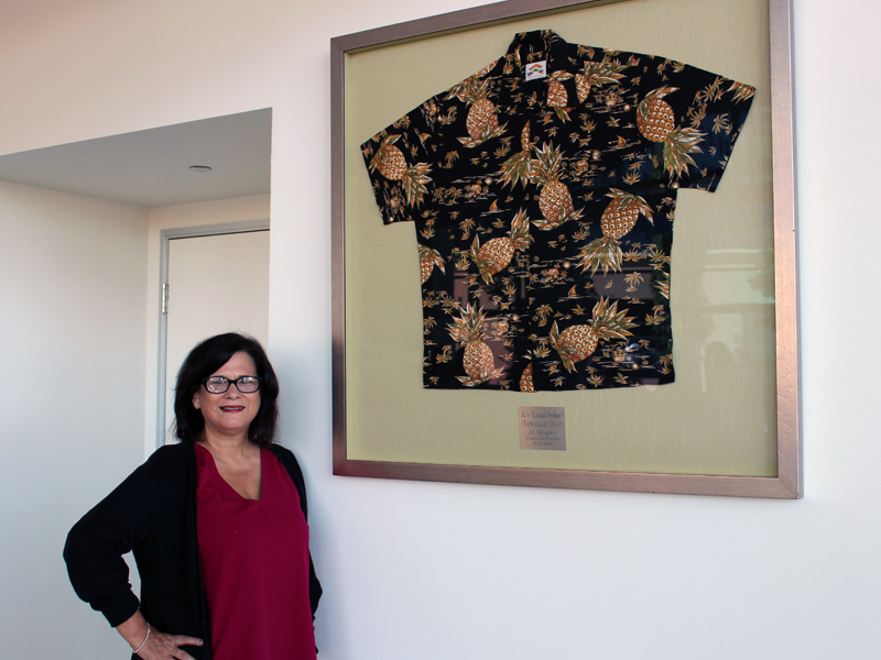 Karen Seifert with one of Al Shugart’s many tropical shirts, on display in the lobby at Seagate in Cupertino, Calif.
